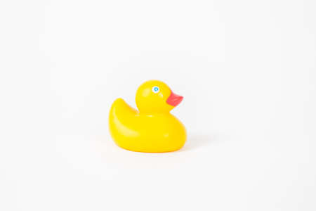A child's rubber duck bath toy on a white background.の写真素材