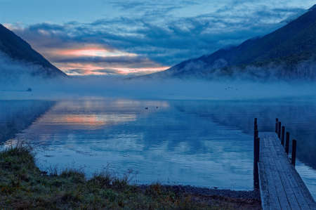 Sunrise ove Lake Rotoiti from Coldwater hut boat jetty at Nelson Lakes National Park, New Zealand.の写真素材