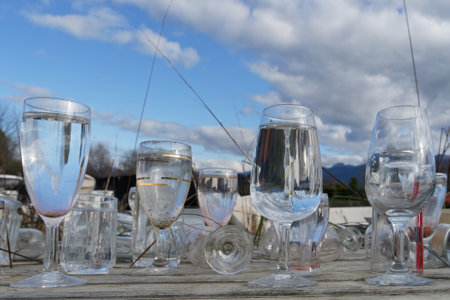 Motueka, Tasman/New Zealand - August 2, 2019: Wine glasses filled with rain water at a recycle centre.のeditorial素材