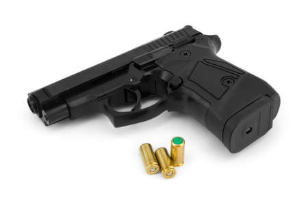 Closeup of a black blank firing pistol and blank cartridges, isolated on white background 