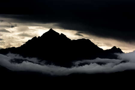 Silhouette of a mountain at sunset in the Alps の写真素材