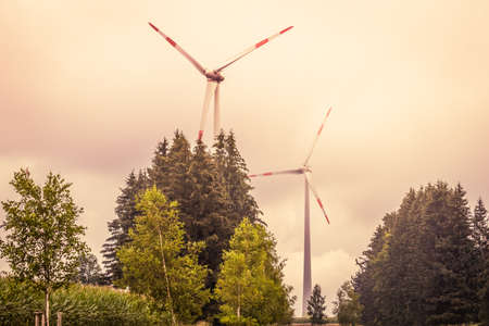 Wind turbines on the fields in the light of the autumn sun.の写真素材