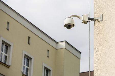 Security camera on a building set on the observations of the street and people の写真素材