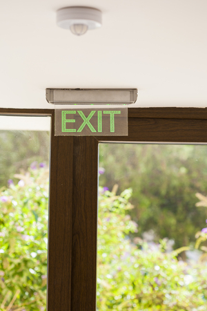 Emergency exit signs hanging above the door 