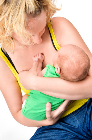 Happy family. Mother is holding her newborn baby with love. Isolated on whiteの写真素材