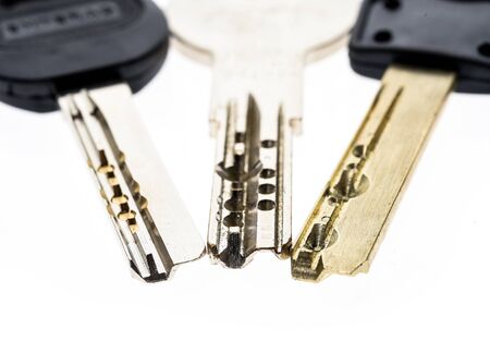 Bunch of Mechanical security anti theft burglary protection silver keys isolated on white. Concept...
