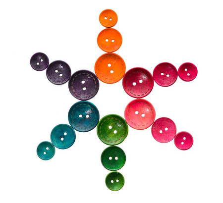 Different color star shaped sewing buttons in a flower shape. Creative colorful pattern background high resolution photoの写真素材