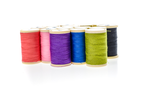 Different color Sewing Threads on a roll. Isolated on white background. Sewing accessories for hobby...