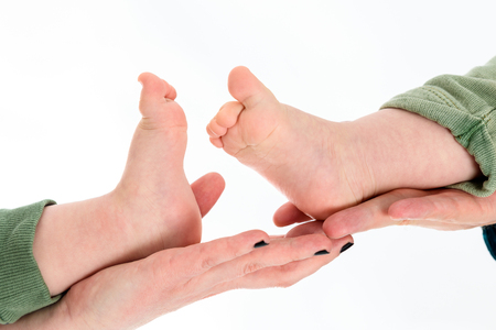 Little Baby Twins Feet in parents hands. Parenthood, family, twins, children and love concept.の写真素材