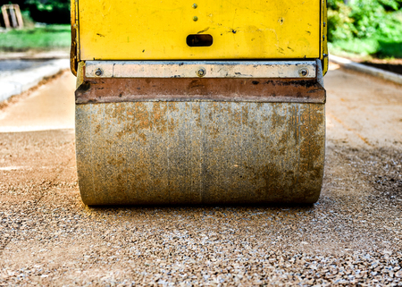 Construction roller or steamroller during road construction. Asphalt pavement works. Lower layer...