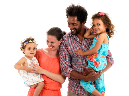 Happy interracial family is celebrating, laughing and having fun with Hispanic African American Father, Caucasian mother and Mulatto children daughters.  Isolated on white.の写真素材