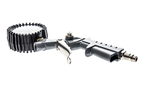 Air compressor gun with manometer isolated on a white background. Close up of blow gun for...
