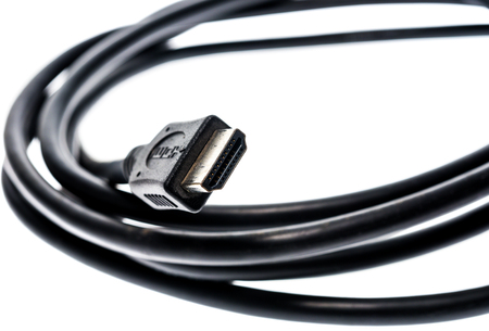 Black audio video HDMI computer cable isolated on white background. Close up of home entertainment...