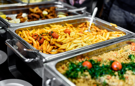 Cuisine Culinary Buffet Dinner Catering Dining Food Celebration Party Concept. Group of people in all you can eat catering buffet food indoor in luxury restaurant with meat and vegetables.の写真素材