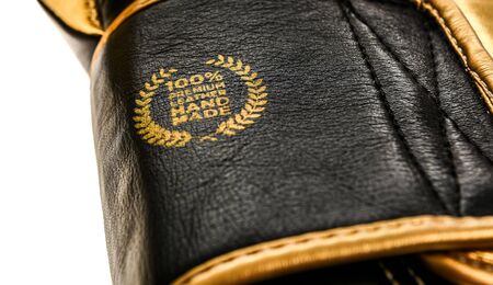 Genuine premium leather handmade sign badge on boxing gloves. Authentic leather product.の写真素材