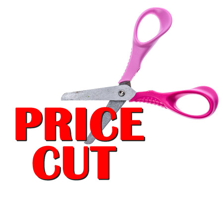 Scissors and Cut Price sale text concept. Children scissors are cutting into a word Cut Prices.の写真素材