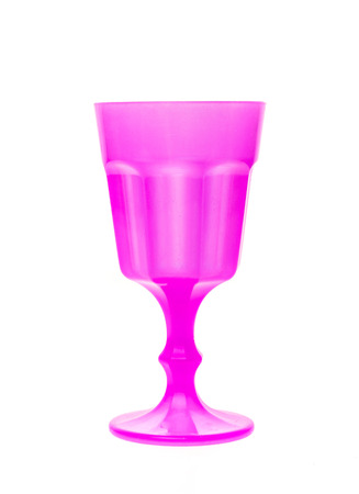 Plastic toy vine or champagne glass isolated on white. Pink toy plastic cup with tall pedestal.の写真素材