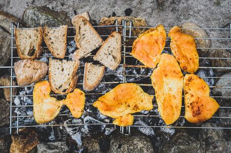 Chicken and bread on homemade improvised BBQ barbecue grill.の写真素材