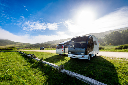 Motorhome RV and campervan are parked on a beach. Two motor home caravans are parked on a parking space for RV vehicles in Galicia - Spain.の写真素材