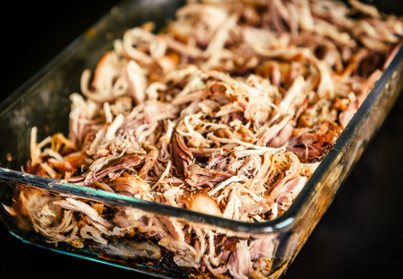 Pulled pork from oven in glass bowl ready for serving. Home made pulled pork made in house oven, smoker or barbecue bbq is ready to be eaten.の写真素材