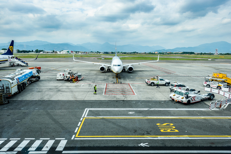 Milano, Italy - MAY 10, 2017: Resupplying and servicing Ryanair plane for flight from Milano Italy to Santiago de Compostela Spain on a sunny day. Terminal with Ryanair planes. Ryanair is biggest budget low-cost airline in the world.のeditorial素材