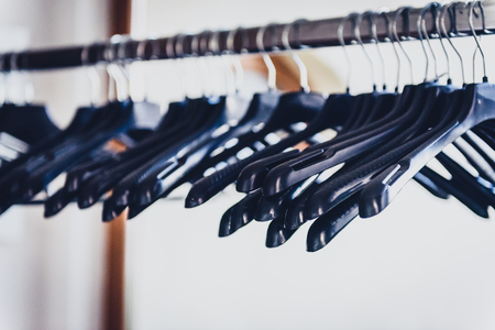 Empty wardrobe stand with black hangers at business event venue. Empty clothing rack at the theatre or business party.の写真素材