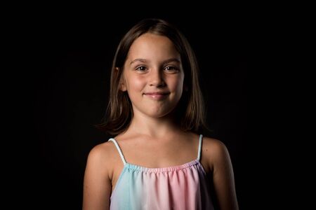 Portrait of happy young little girl with emotions on black. Portrait of a cheerful cute little child...
