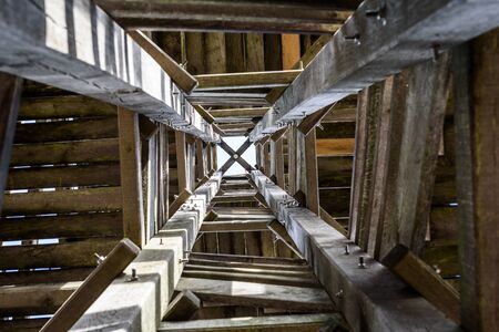 Wooden forest watchtower viewing tower construction close up. A shot from unter the wooden tower and its massive construction.の写真素材