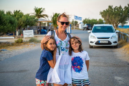 Family with kids tourists portrait standing on beach, Xerokampos, Crete, Greece. Active family vacation in the summer in Greece visiting Xerokampos beach. Mother with children traveling.の写真素材
