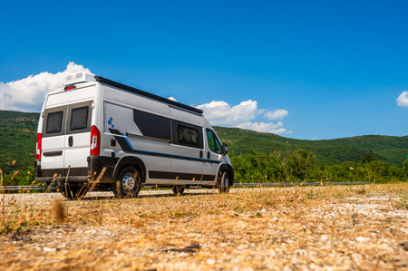 Campervan, Motorhome RV parked on the side of the road, Meteora, Greece. Travelers with camperÂ van are resting on an active family vacation on a road trip in Greece.の写真素材