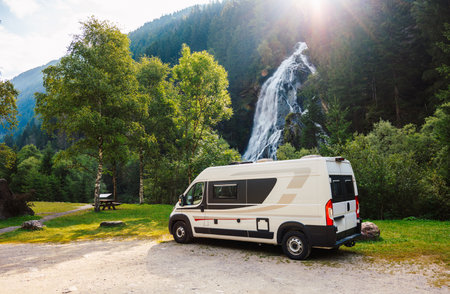Campervan or motorhome parked in picnic resting area in front of...