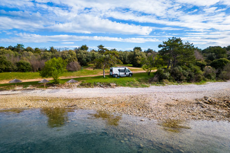 Camper van or motor home is parked on a beach. Relaxing holidayÂ on a beautifulÂ beachÂ with RV camper van on family vacation inÂ Croatia.の写真素材
