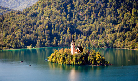 Lake Bled Slovenia. Beautiful mountain lake with small Pilgrimage Church. Most famous Slovenian lake and island Bled with Pilgrimage Church of the Assumption of Maria. View from Castle Bledの写真素材