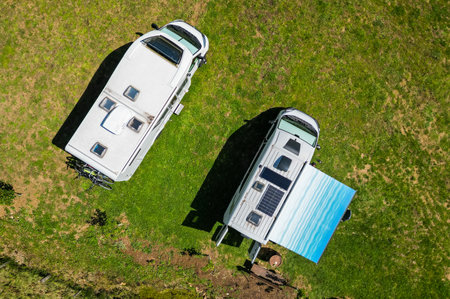 Top down birds view of campervan and motorhome. Drone photo of camper van or motor home, withroof windows and solar panels.の写真素材