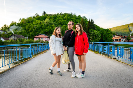 Family taking a picture on Kulen Vakuf bridge in Bosnia. Family visiting a famous bridge over the Una river to enter the small town of Kulen Vakuf in Bosnia.の写真素材