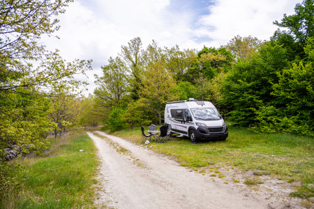 Camper van or motorhome is free camping on the side of the road on BuÅ¡ko lake, Bosnia and Herzegovina. Wild camping in Bosnia, Greece or Croatia in nature next to the lake.の写真素材