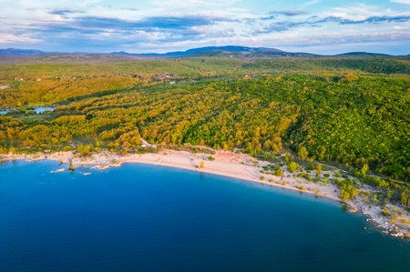 Aerial view of BuÅ¡ko lake in Bosnia and Herzegovina. ArtificialÂ lake with some motorhomes or campervansÂ free camping on the beach.の写真素材