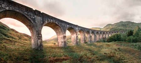 Glenfinnan Railway Viaduct.  famous Glenfinnan viaduct, Scotland in cloudy weather and sunrise in the background.の写真素材