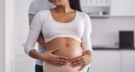 A Radiant Pregnant Young Woman Holds Her Belly, Nurturing the Promise of New Life. Generative AIの素材