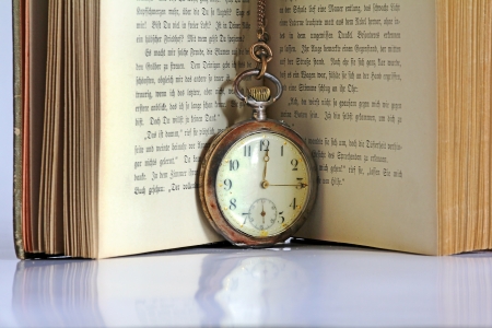 The ancient book and old pocket watchの写真素材