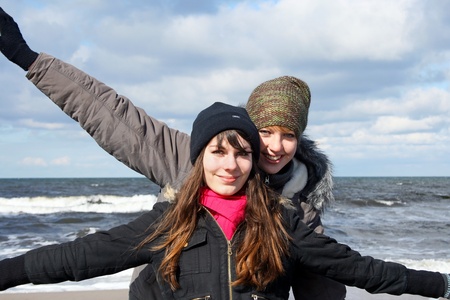 Two girlfriends have fun at the sea