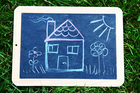 Ownership A house on a blackboard. A drawing of a houseの写真素材