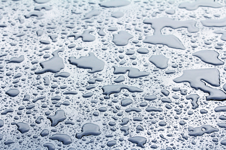 On a rainy day there is water puddles forming on a carの写真素材