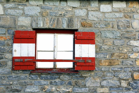 A mountain hut in Austria. Austrian window with red and white shutters