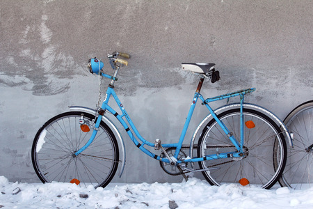 An old blue bicycle on a house wallの写真素材