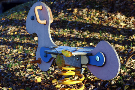 A children's toy on a playground in autumn. Lonely children's playgroundの写真素材
