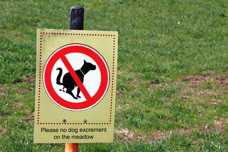 Sign with No Dog Excrement on the meadow