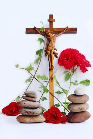 A Christian cross with red roses, ivy and stone towersの写真素材