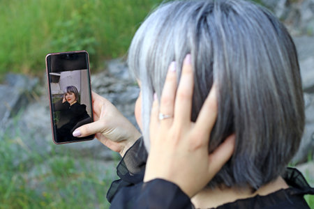 A woman takes a selfie of herselfの写真素材