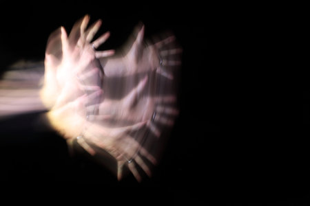 Long exposure of a woman's hand at nightの写真素材